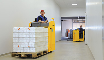 Operators Driving Jungheinrich ESE Series Pallet Trucks down a Hallway